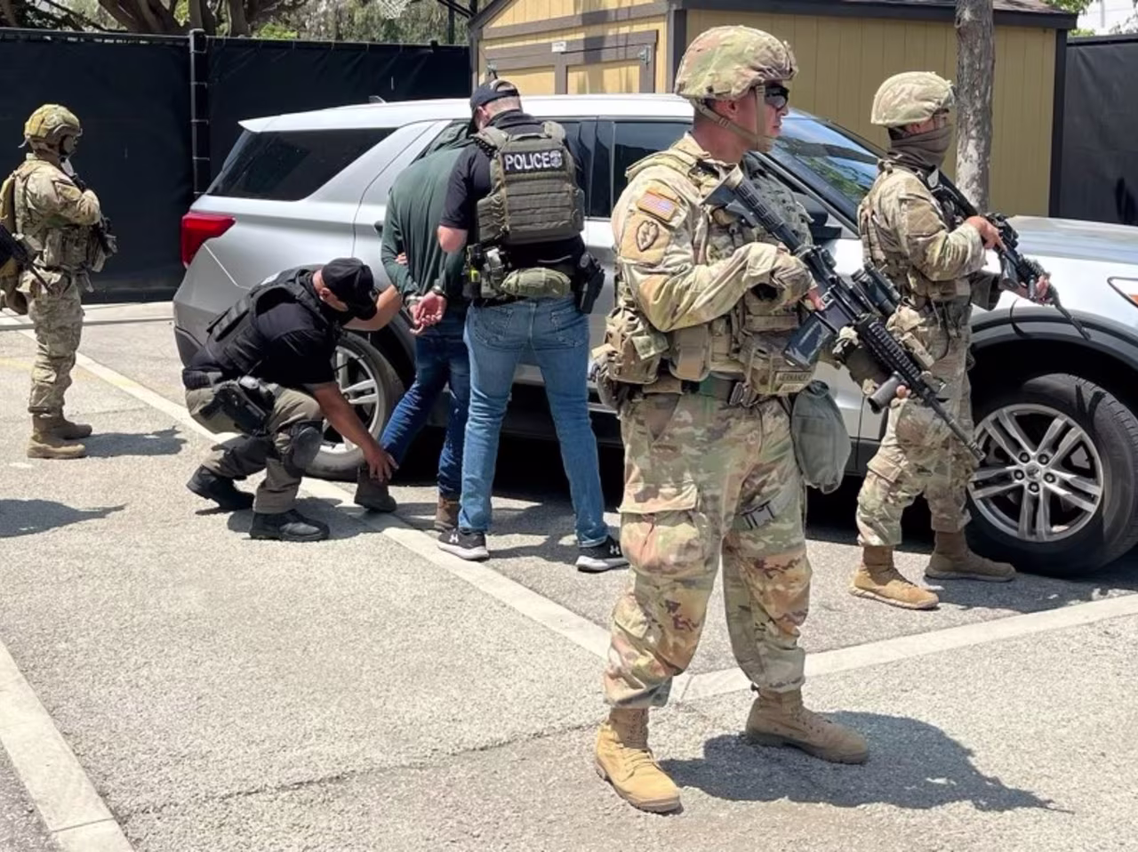Immigration and Customs Enforcement posted images on X today of officers detaining individuals in Los Angeles while surrounded by National Guard troops, in what appears to be the first photos marking the Guard involved in ICE operations.