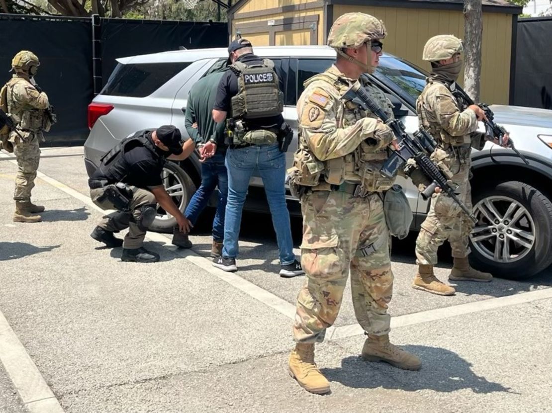 National Guard troops guard Immigration and Customs Enforcement officers during an operation in Los Angeles, in this image shared by ICE on Tuesday, June 10, 2025.