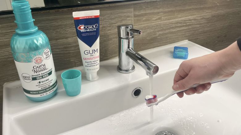 Bathroom sink with best products for gum sensitivity.