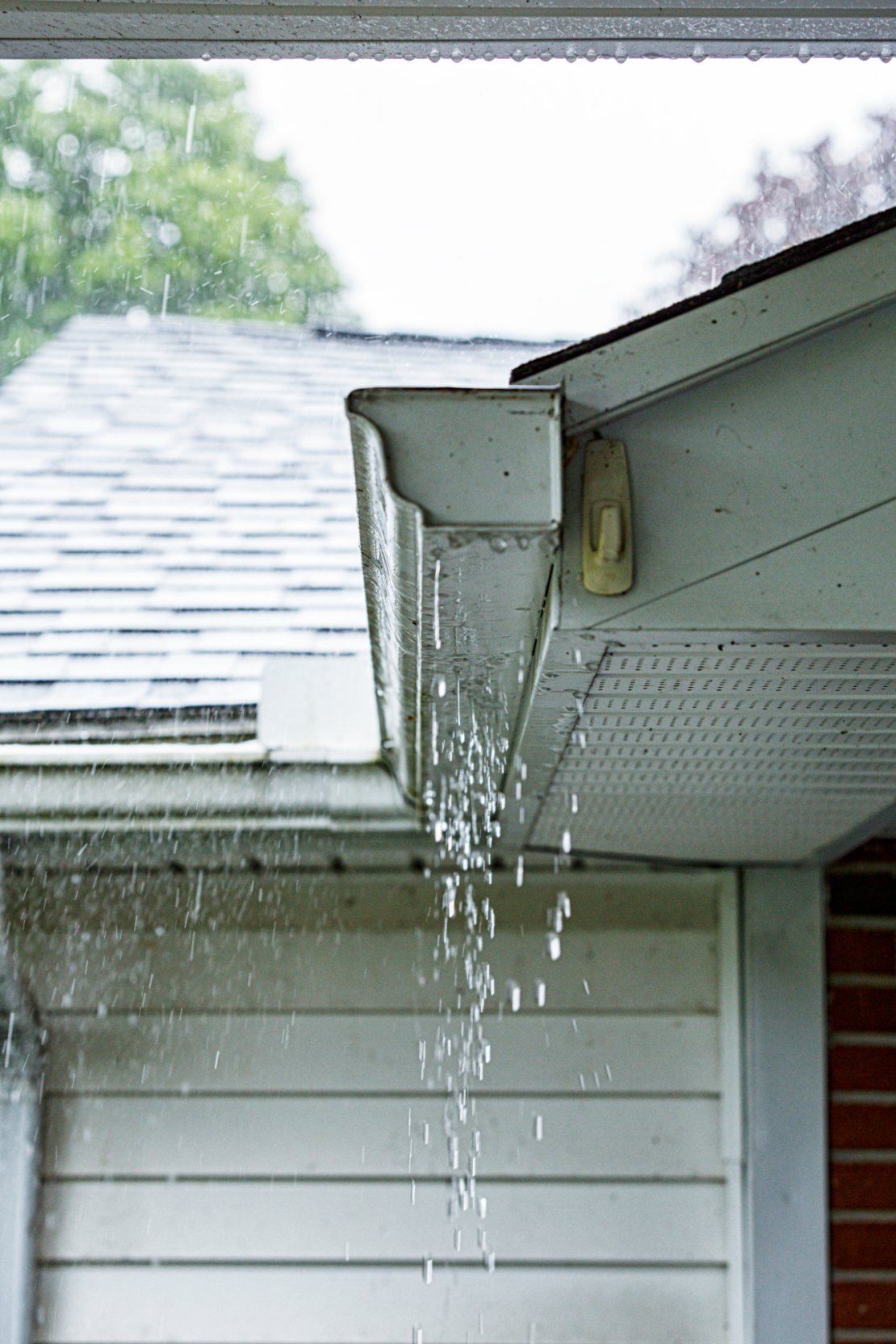 Aluminum K-style gutter on a suburban home during a rainstorm