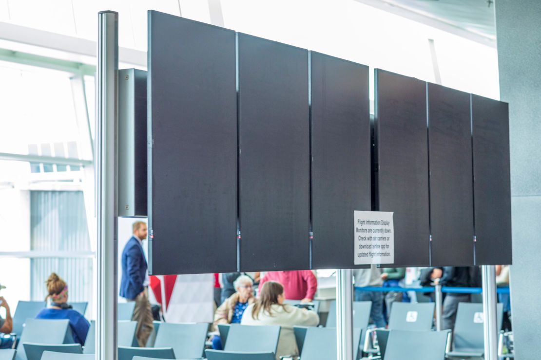 Blank screens are seen at Seattle-Tacoma International Airport during a computer system outage.