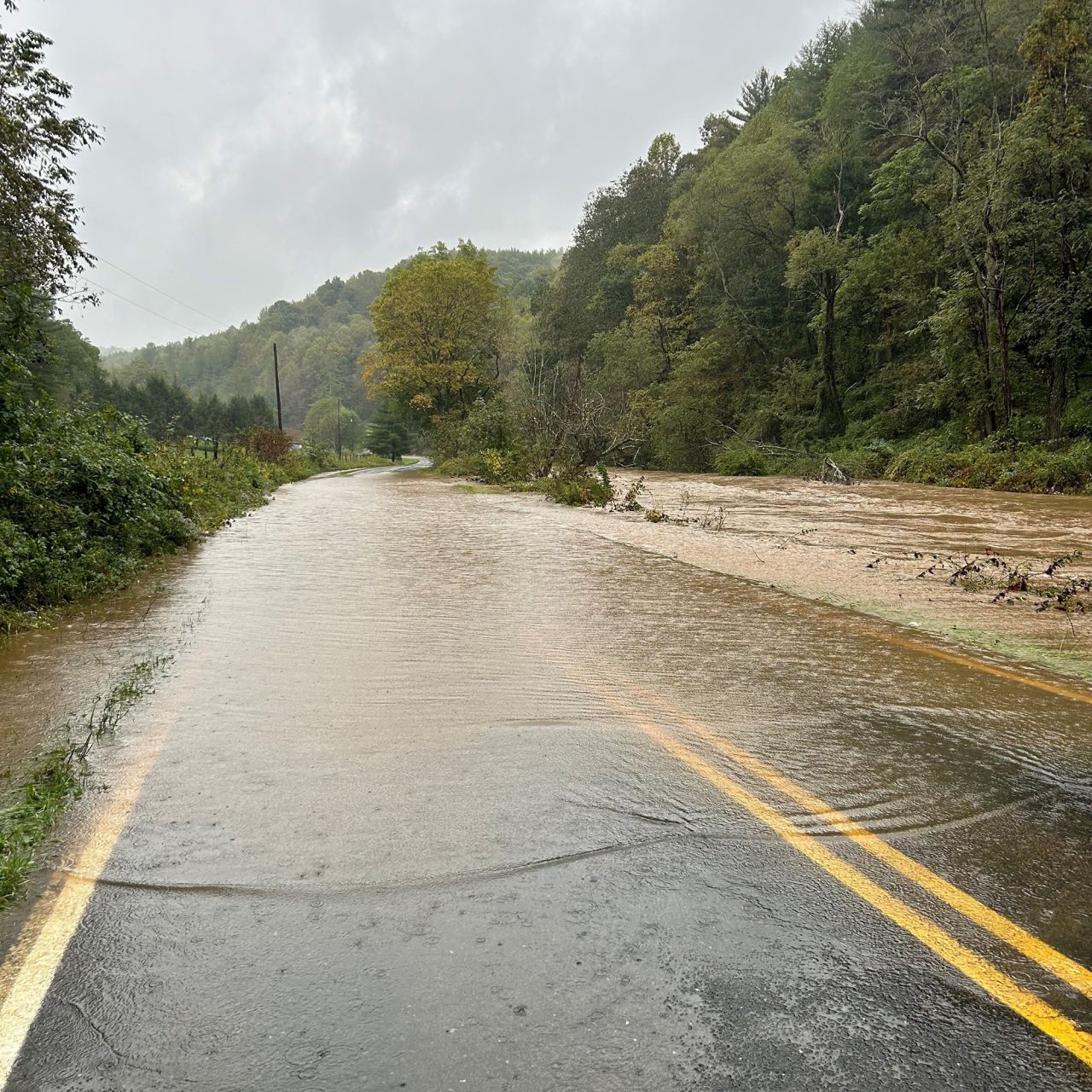 In this photo posted to X by the NCDOT, a road in western North Carolina is flooded on Friday.