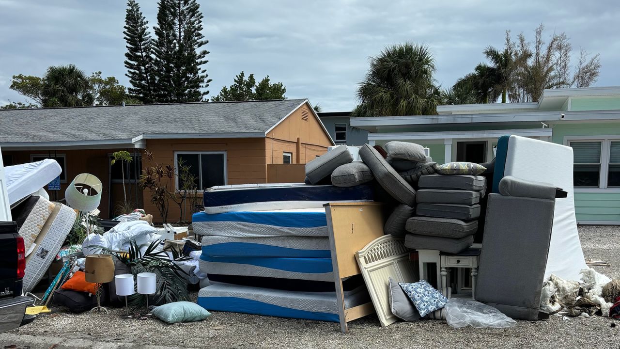 Damaged home items are piled along a road in Clearwater, Florida.