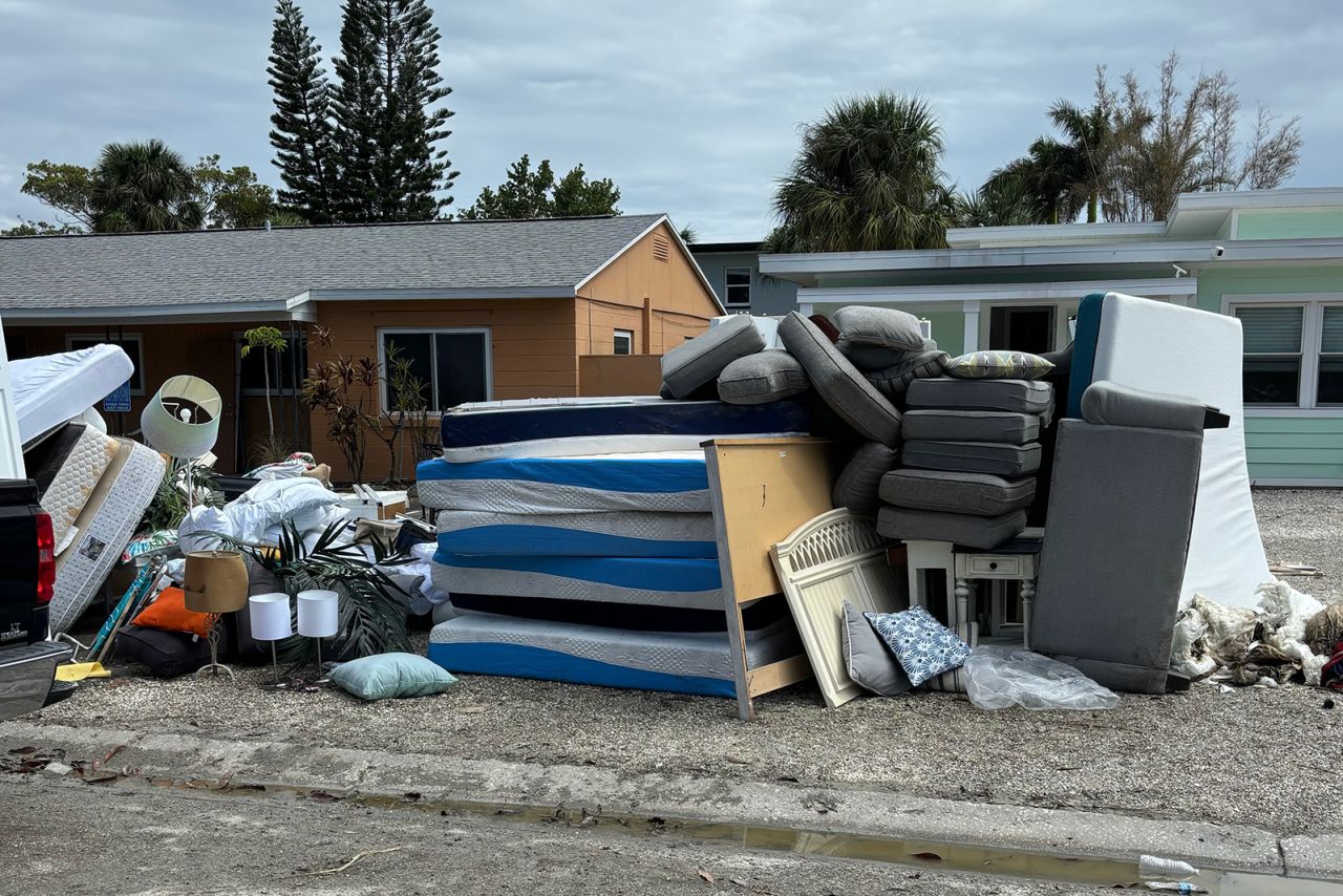 Damaged home items are piled along a road in Clearwater, Florida.