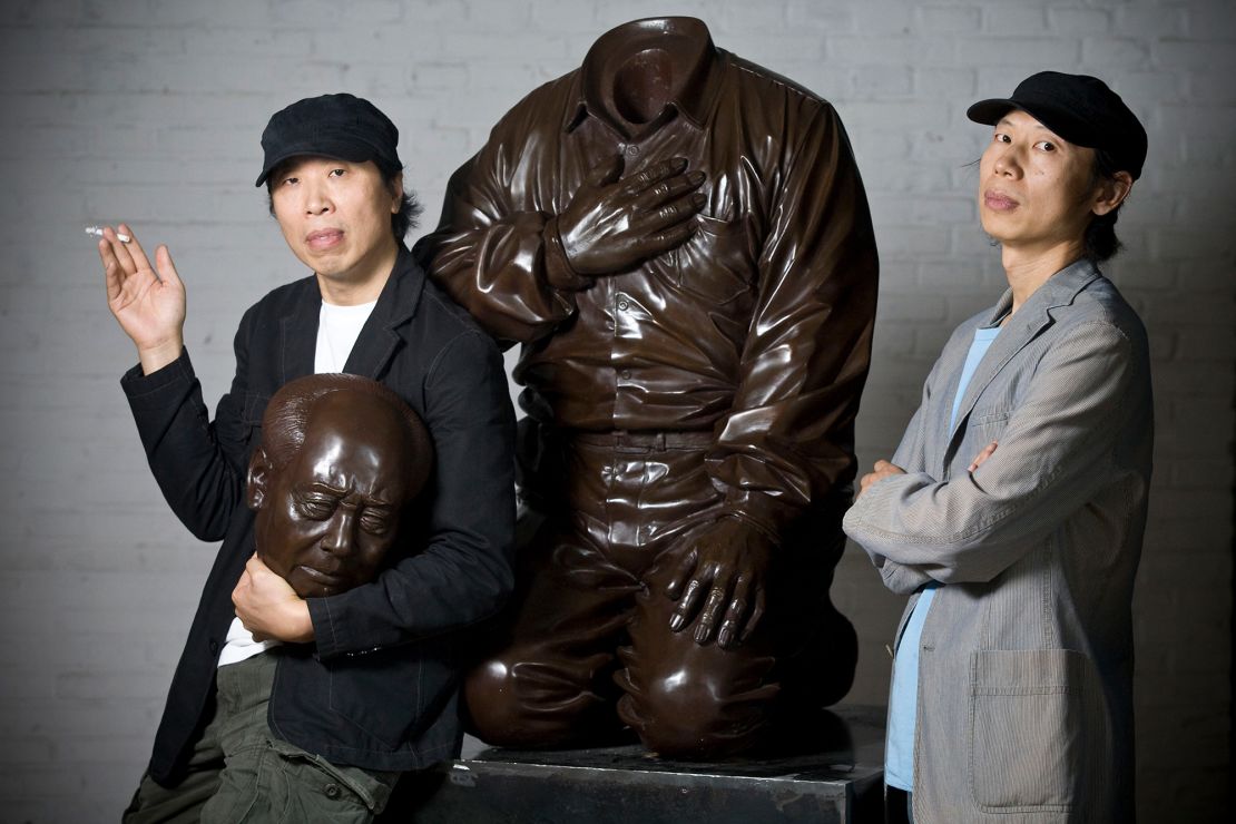 Artist brothers Gao Zhen (left) and Gao Qiang (right) pictured with their sculpture "Mao's Guilt" in Beijing, China, in 2009.