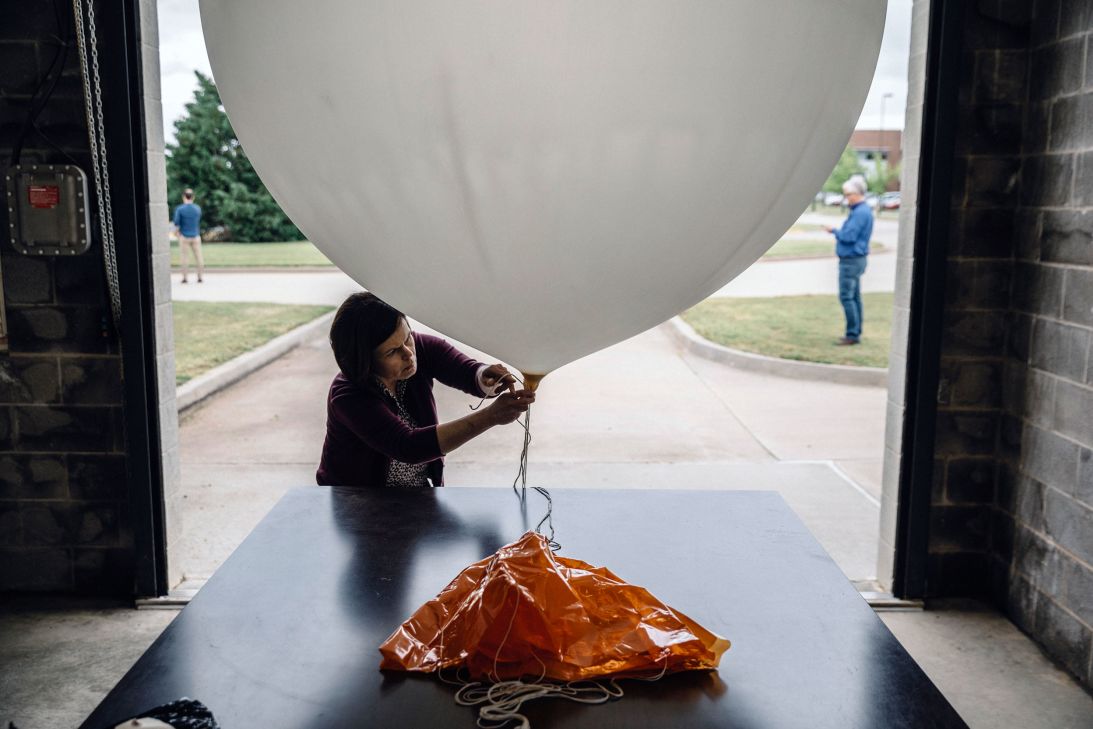 A meteorologist at the National Weather Service's Storm Prediction Center in Norman, Oklahoma, prepares a weather balloon for release in 2019.