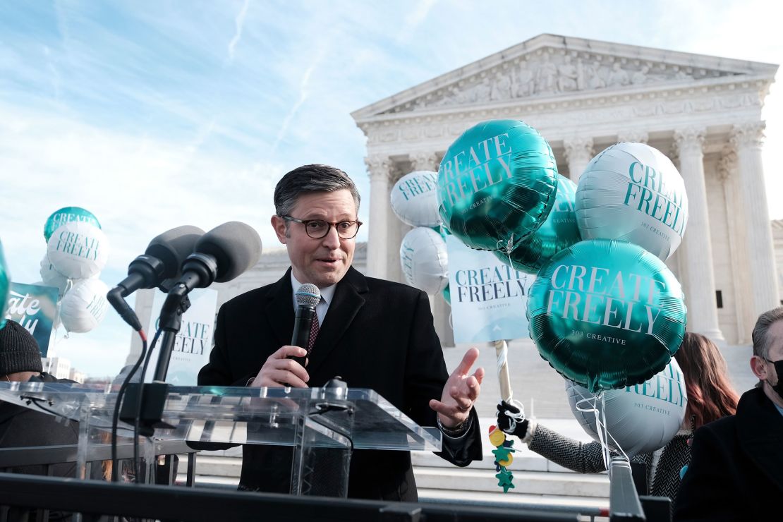 Rep. Mike Johnson speaking outside the U.S. Supreme Court building in Washington during arguments over whether businesses may decline services for same-sex weddings in December 2022.