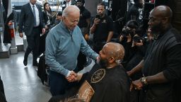 President Joe Biden talks with patrons and employees at a barber shop in Columbia, South Carolina, on January 27.