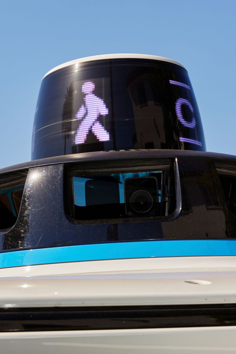 A pedestrian symbol is displayed on a Waymo in Los Angeles.