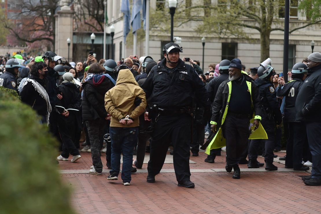 Police officers detain pro-Palestinian demonstrators who had set up an encampment on the South Lawn at Columbia University in New York, on Thursday afternoon.