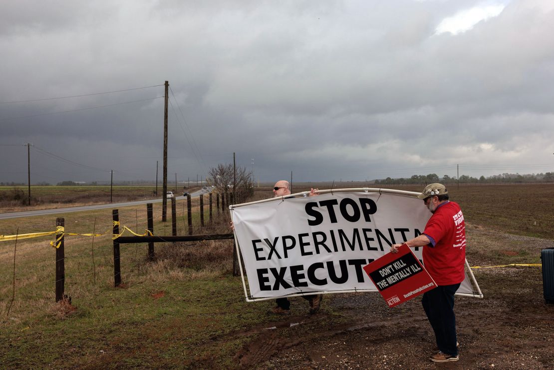 Demonstrators walk outside William C. Holman Prison in Atmore, Alabama, in the hours before the January execution of Kenneth Smith.