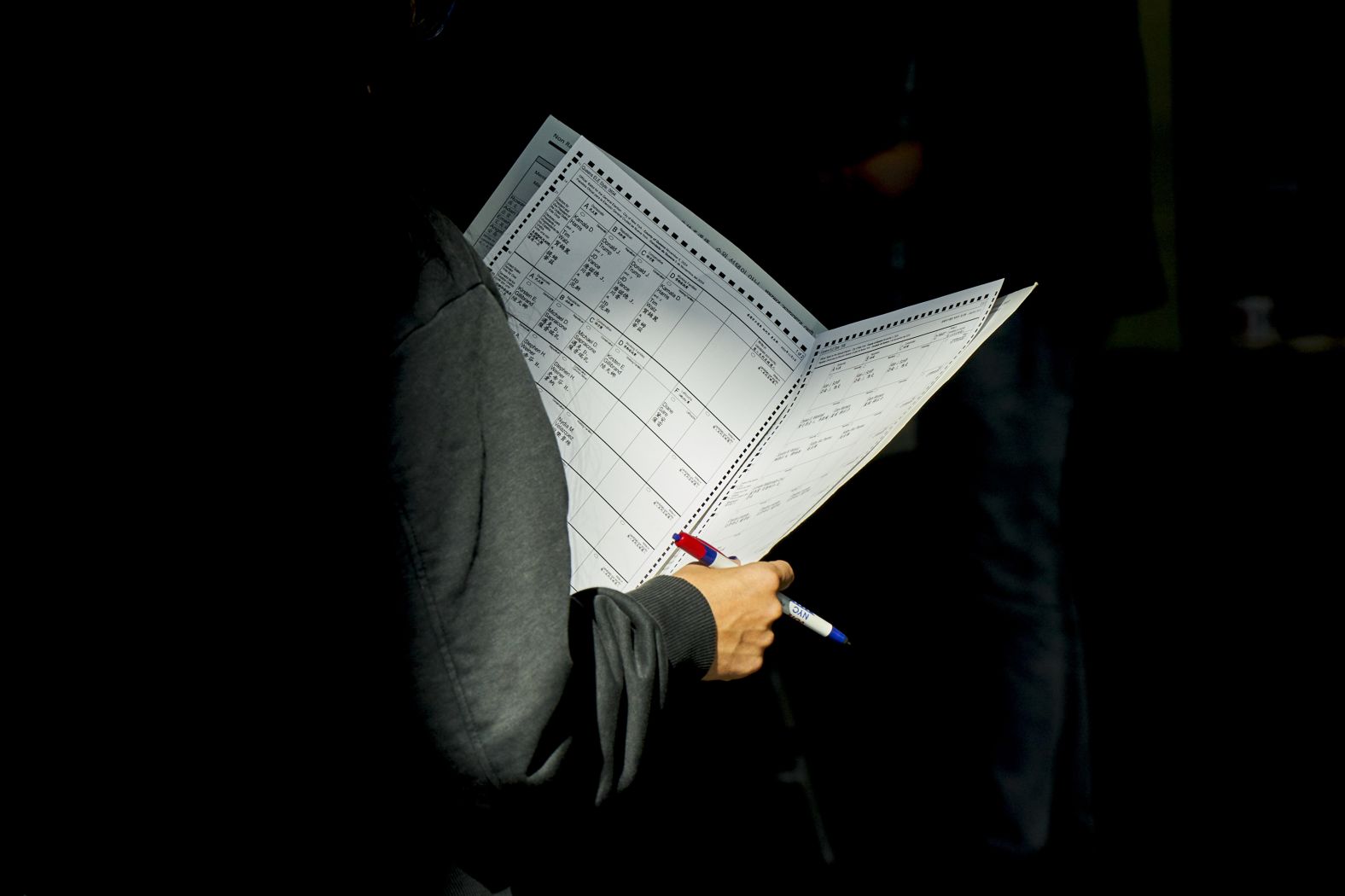 A woman looks at a ballot while in line for early voting in New York on October 27.