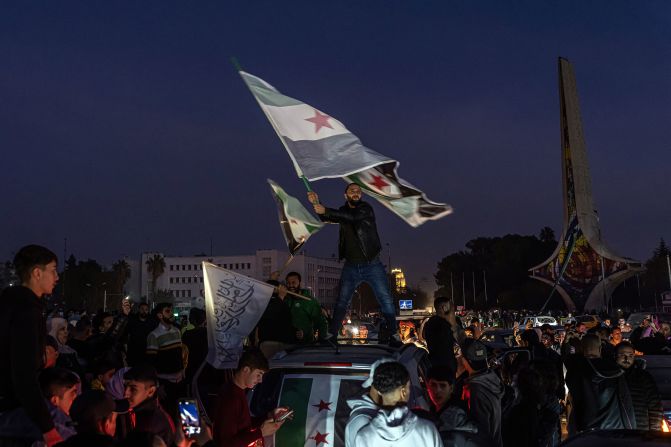 People gather in Umayyad Square in Damascus on December 9 to celebrate the fall of the Assad regime.