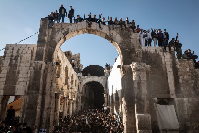 Syrians gather at the historic Umayyad Mosque in Damascus on December 13 for the first Friday prayers since rebels toppled Syrian President Bashar al-Assad.