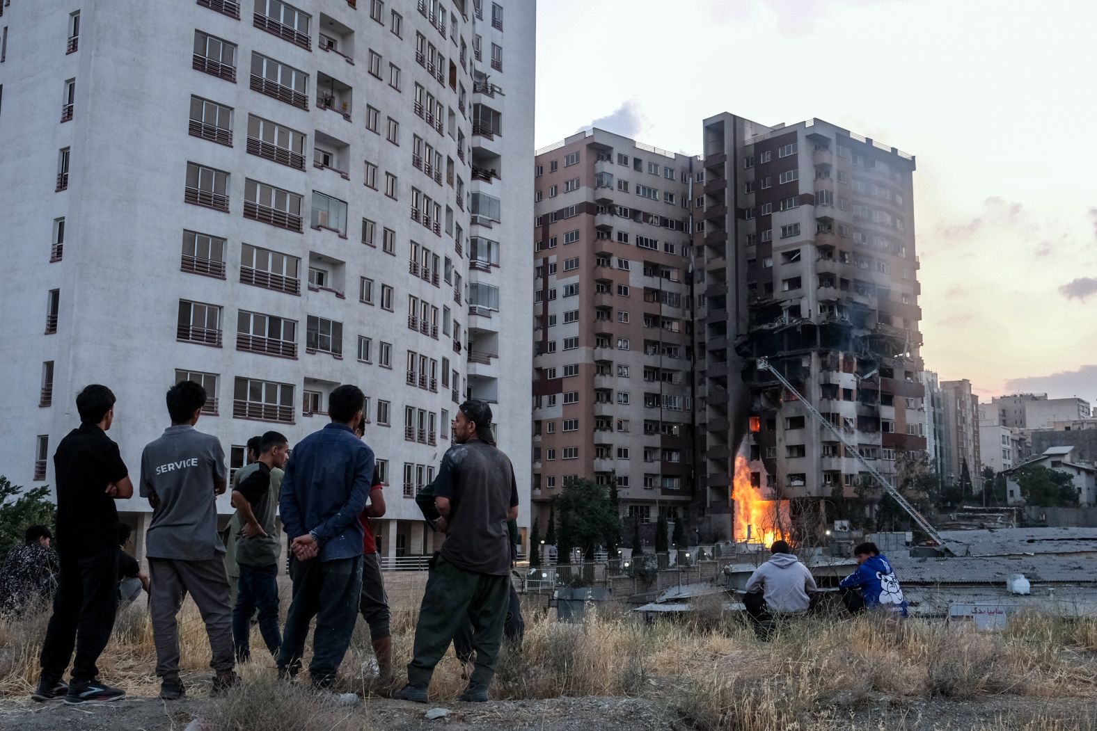 People look at damage in Tehran on Friday.