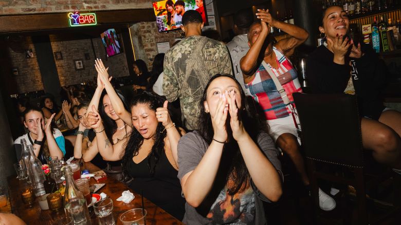 Viewers at a "Love Island USA" watch party at the Malt House, a bar in the Greenwich Village section of New York, July 1, 2025. The reality-TV show draws viewers in with steamy drama and over-the-top challenges, but what's more surprising is how it's bringing people together. (Lanna Apisukh/The New York Times)