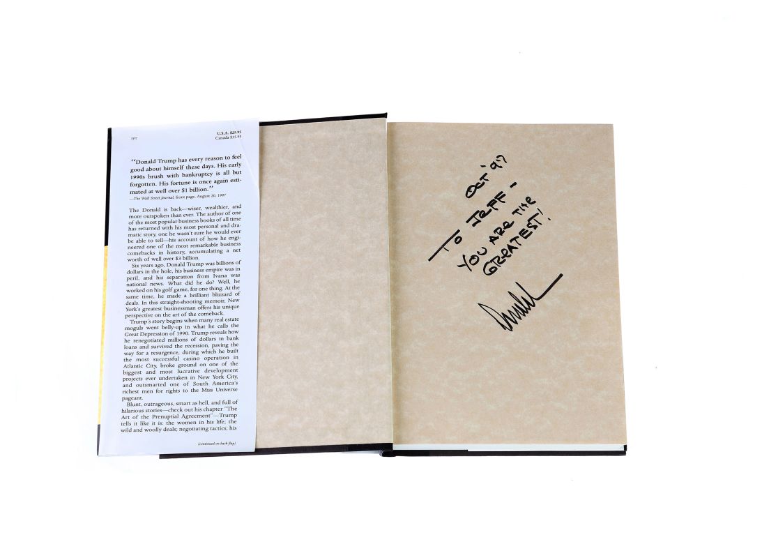 A photo of an inscription in a copy of Donald Trump's book "Trump: The Art of the Comeback" that belonged to Jeffrey Epstein. President Trump's name appeared on a contributor list for a book celebrating the 50th birthday of the disgraced financier Jeffrey Epstein, evidence that he participated in the collection even as he denied that he signed a sexually suggestive note and drawing.