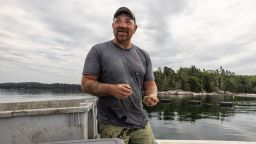 FILE -- Graham Platner shucks oysters on site of the farm he co-runs in Waukeag Neck Oyster Co. in the Frenchman Bay in Sullivan, Maine, June 25, 2025. A new crop of candidates has turned away from the aspirational "American dream" message of campaigns past and is leaning into how difficult life can be for working people -- including them. (Greta Rybus/The New York Times)