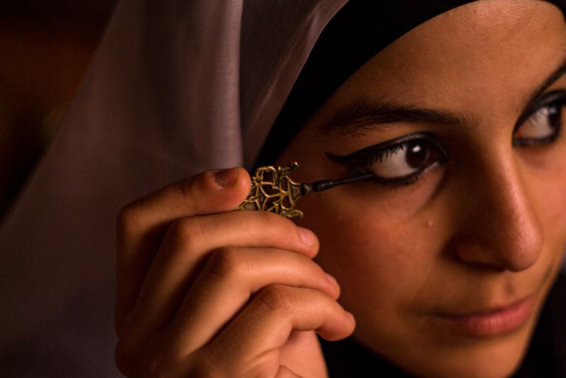 A bride paints on kohl at her wedding. Eyeliner has been used for medicinal, cultural and beautification purposes for thousands of years.