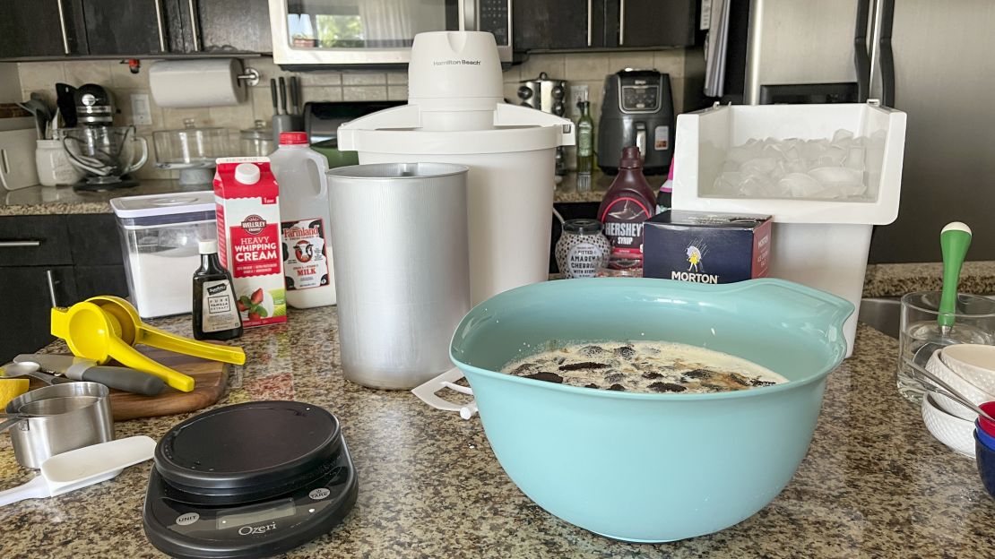 A kitchen counter is full of ice cream-making ingredients.