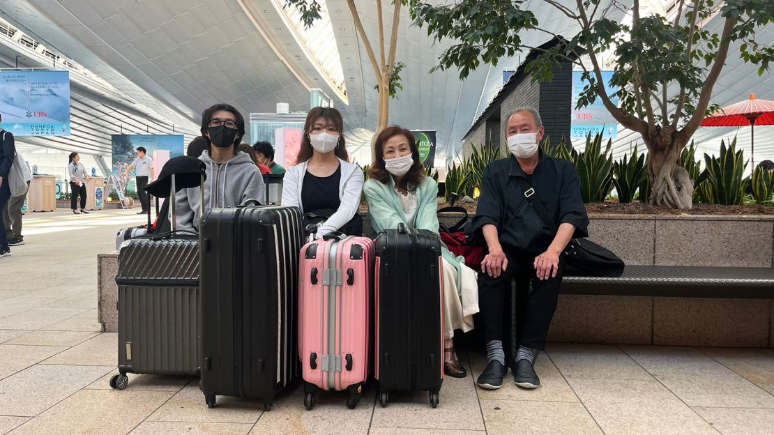 Sato Hitomi, third from left, is about to leave for Hawaii with her family from Tokyo's Haneda Airport.