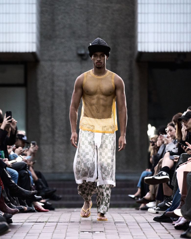 Latex mesh shirts and Bermuda shorts were part of HARRI's latex-style streetwear.