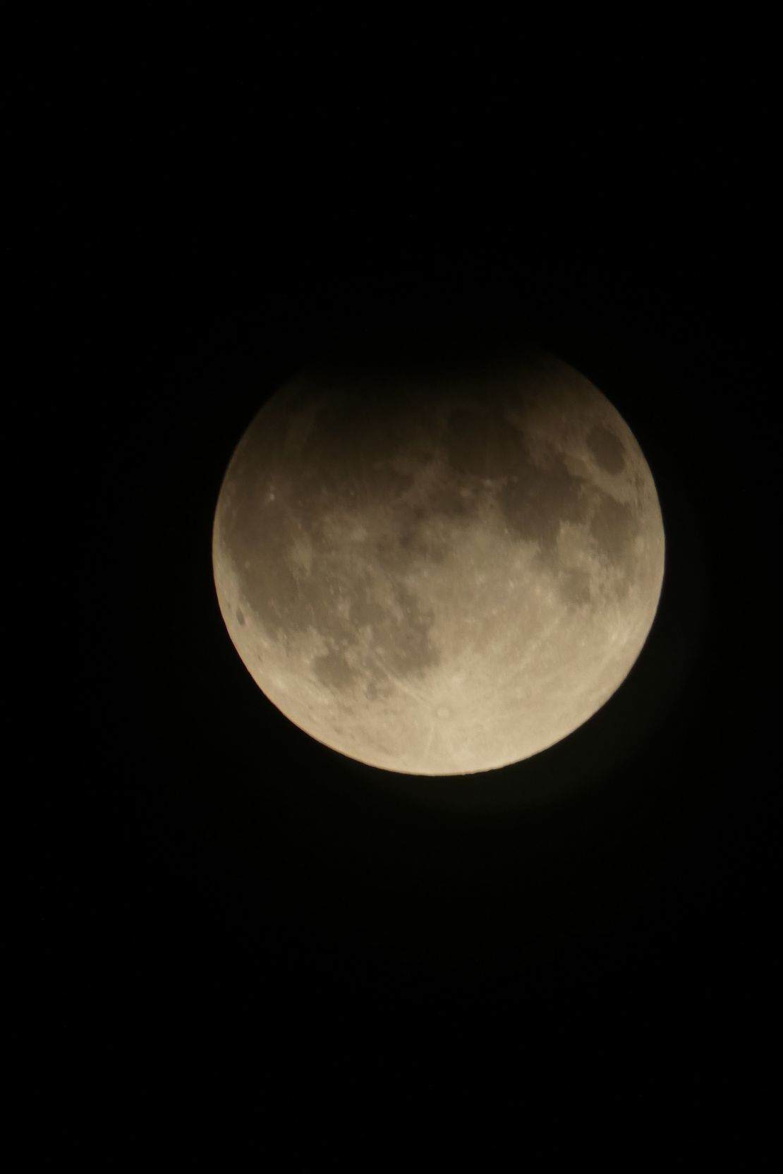 The harvest moon is seen over Toronto during a partial lunar eclipse on Wednesday.