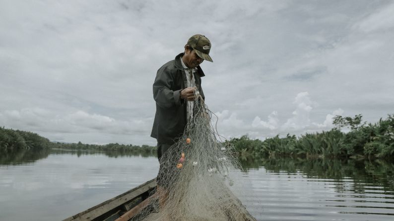 As well as buying chainsaws, HIH offers people training in alternative livelihoods, such as organic farming, beekeeping and fishing. Pictured, Pak Karim has been part of the buyback scheme <a href="https://healthinharmony.org/wp-content/uploads/HIH-Impact-Report-2022.pdf" target="_blank">since 2018</a>, when he sold his chainsaw and became a fisherman.