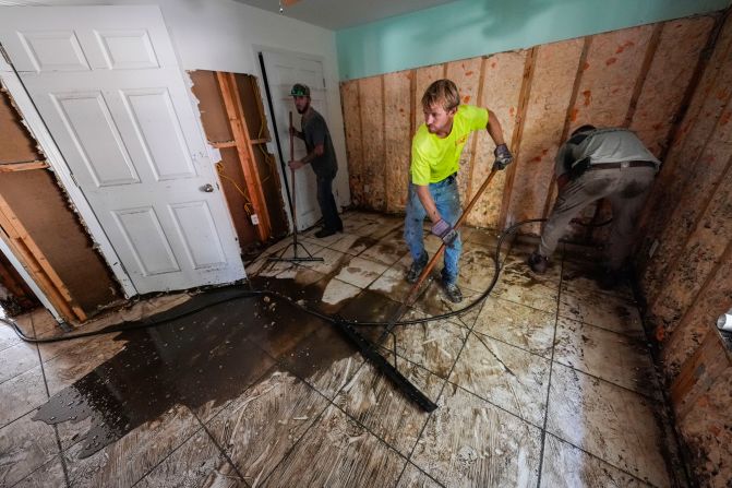 Workers clean and gut a property that was flooded from the storm surge, in the aftermath of Hurricane Helene, in Steinhatchee, Florida, on Sunday, September 29.