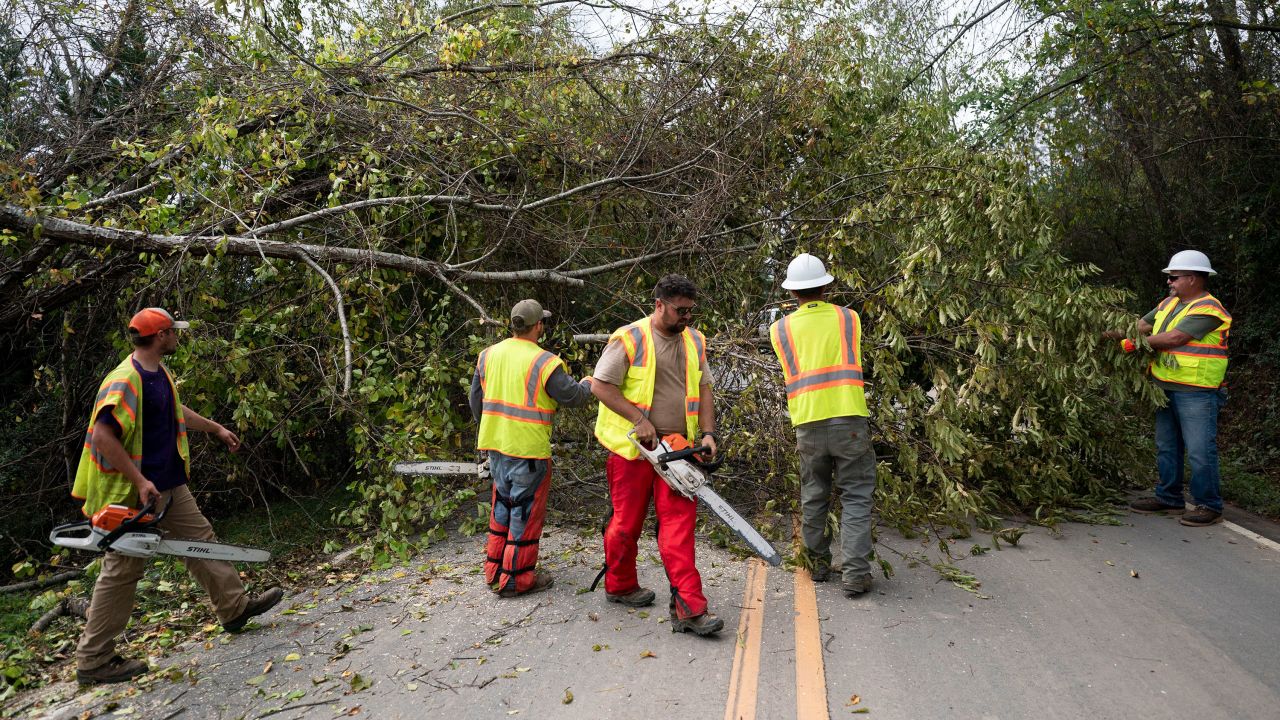 Workers clear a road in Fairview, North Carolina, on Sunday.