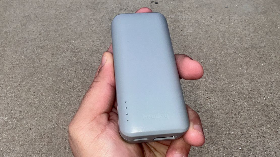 A photo of a hand holding a silver Target Heyday Power Bank