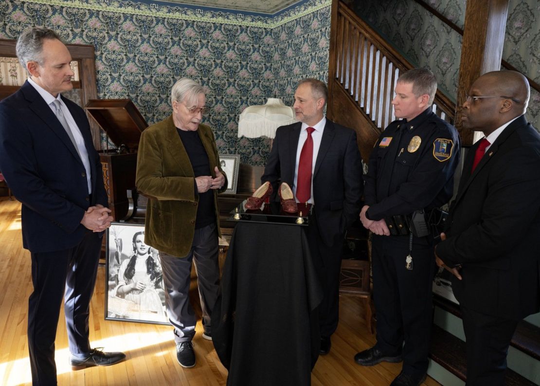 Michael Shaw, second from the left, is pictured being reunited with the slippers he owned for the first time since they were stolen in 2005. FBI agents discovered the shoes in a 2018 sting operation and sent them to the Smithsonian to confirm their authenticity.