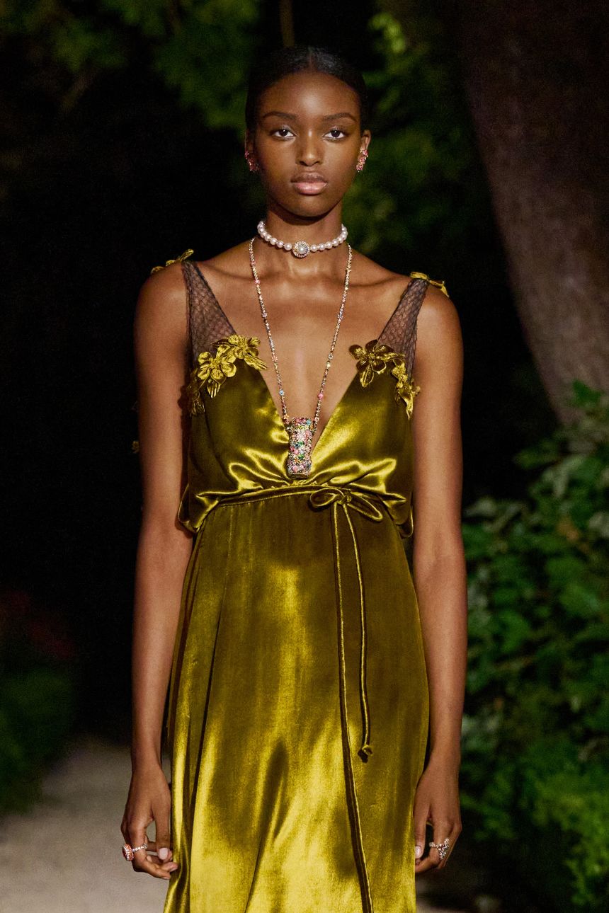 The exquisite pendant around the model's neck is part necklace, part lipstick.