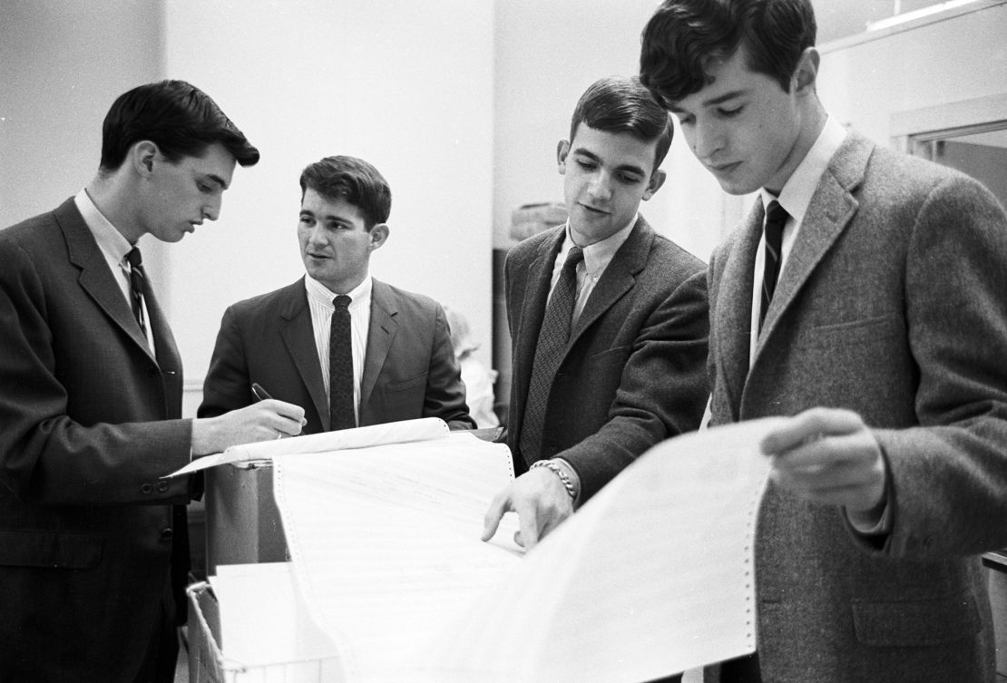 Douglas Ginsburg (far left) and Jeff Tarr (second from left) go over calculations for Operation Match.