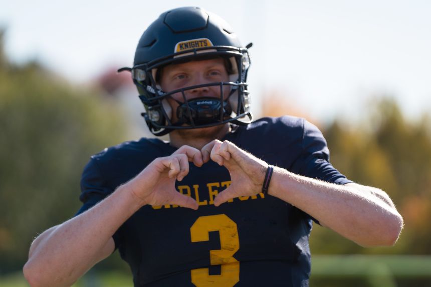 Jack Curtis celebrates with the heart-hands gesture during a game earlier this season. Curtis is having one of the best seasons of his career despite playing through cancer.