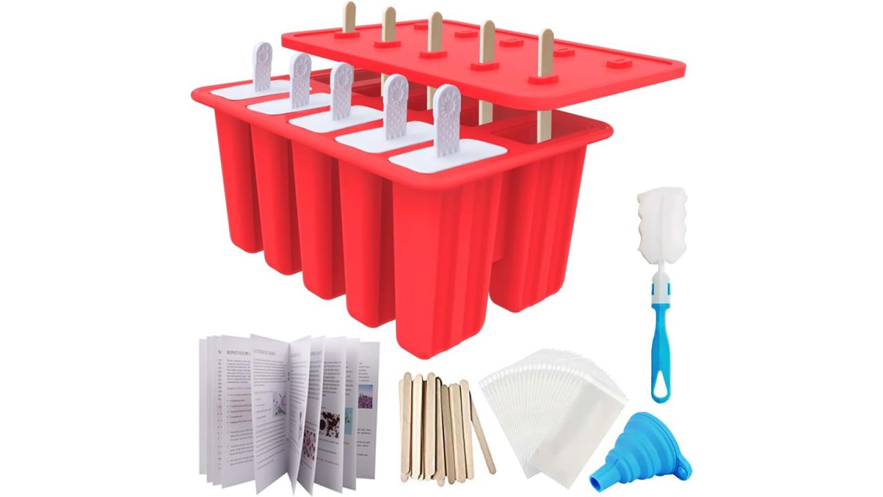 Popsicle molds with cleaner, handbook, sticks placed against white background.