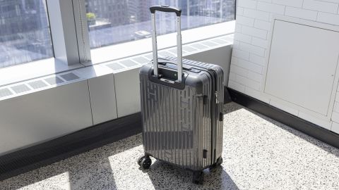 A photo of the exterior of the Hotel Collection Carry-On Luggage next to a window in an urban office building