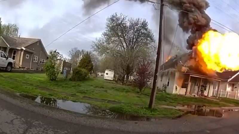 Officers rush to pull firefighter from rubble after burning house explodes