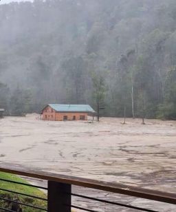 A neighbor took a photo of the Ashby home in Elk Park, North Carolina, as it floated in the river on Friday.