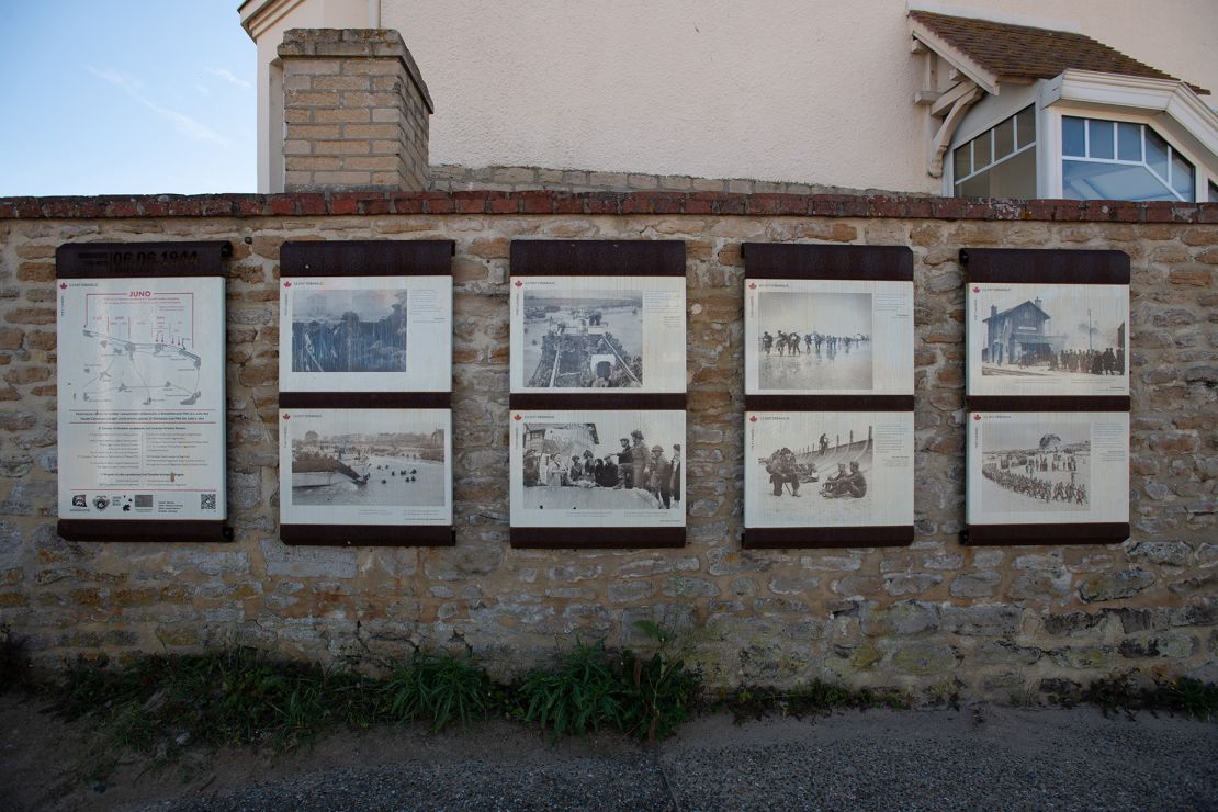 Photographs of the landing at Juno Beach are displayed on the wall next to Canada House.