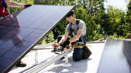 A professional solar panel crew installs panels on the roof of a house in Washington state.