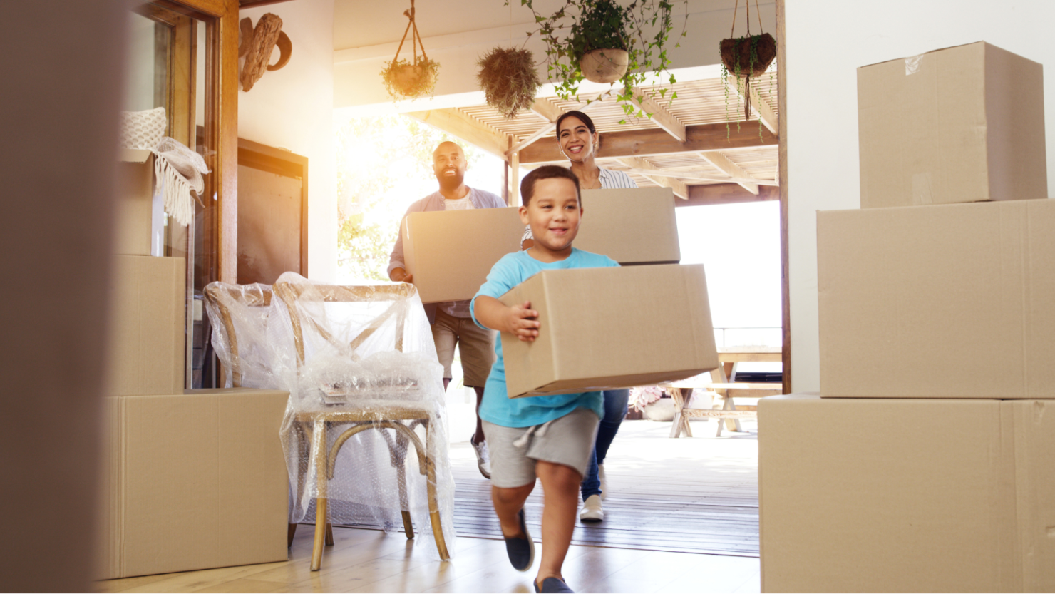 Family moving boxes into a new home