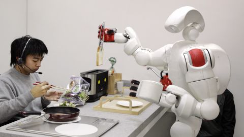 The new humanoid robot "Twendy-one", developed by Japan's Waseda University, picks up a piece of bread from a toaster during a demonstration at Waseda's laboratory in Tokyo, 27 November 2007. The Twendy-one, equipped with 47 actuators and two CCD on its 111kg body, has been developed for nursery and household assistance work.  AFP PHOTO / Yoshikazu TSUNO (Photo credit should read YOSHIKAZU TSUNO/AFP via Getty Images)