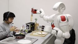 The new humanoid robot "Twendy-one", developed by Japan's Waseda University, picks up a piece of bread from a toaster during a demonstration at Waseda's laboratory in Tokyo, 27 November 2007. The Twendy-one, equipped with 47 actuators and two CCD on its 111kg body, has been developed for nursery and household assistance work. AFP PHOTO / Yoshikazu TSUNO (Photo credit should read YOSHIKAZU TSUNO/AFP via Getty Images)