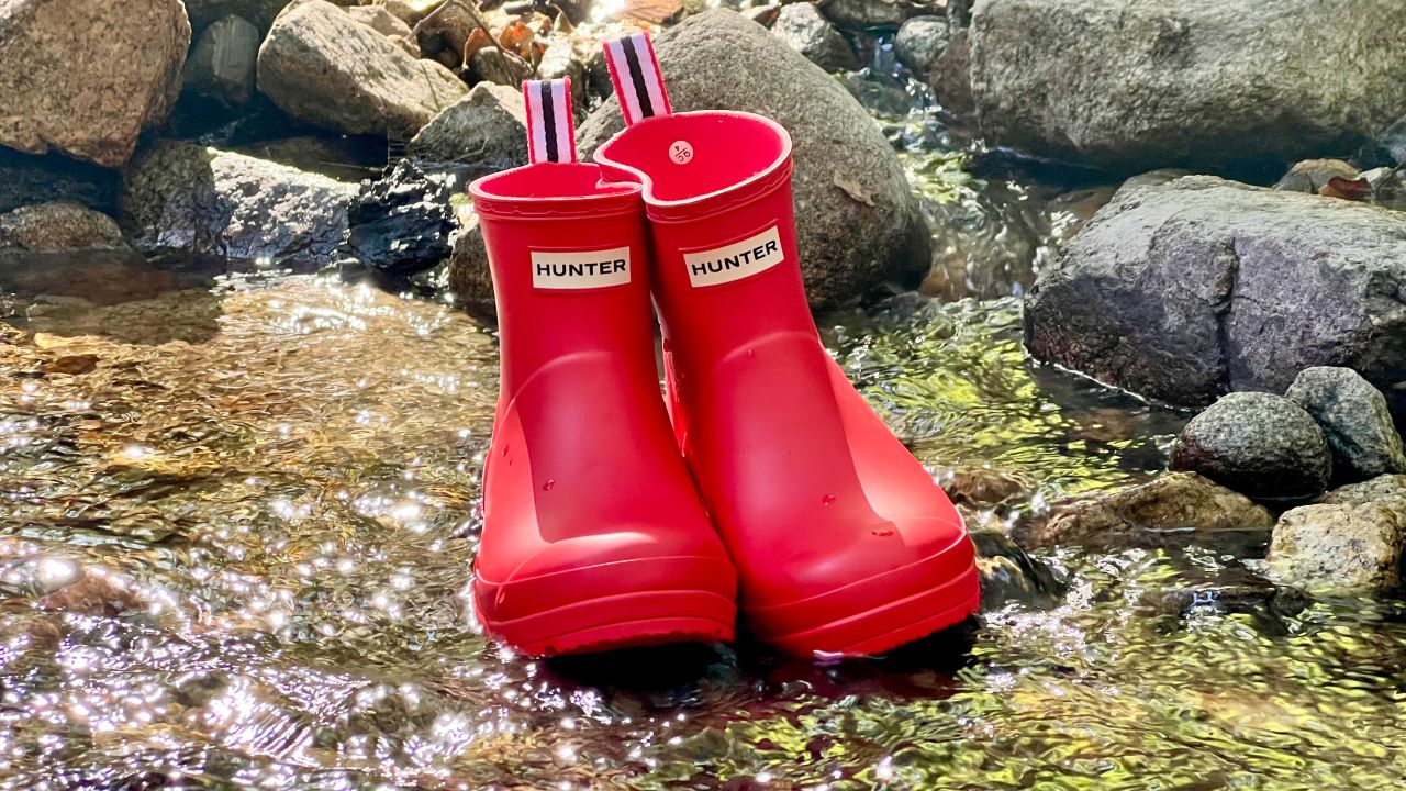 hunter play short boots sitting in a creek