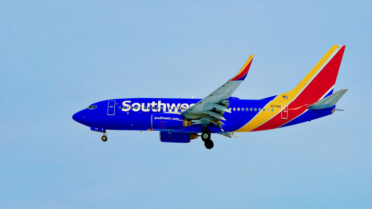 A photo of a Southwest Airlines Boeing 737 against a blue sky over Baltimore.