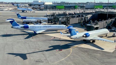 A photo of three United Express jets parked at the gate in Newark Liberty International Airport (EWR)