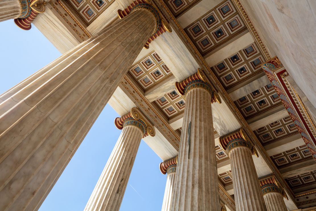 A photo of classical columns at the Athens Academy entrance in Athens, Greece