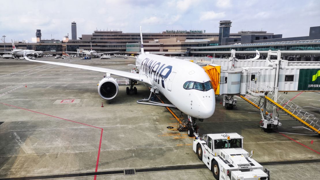 A photo of a Finnair Airbus A350 parked at the gate at Tokyo's Narita International Airport