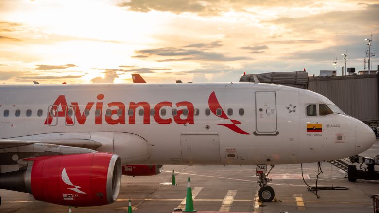 A photo of the side of an Avianca Airbus jet parked at the gate in Bogota